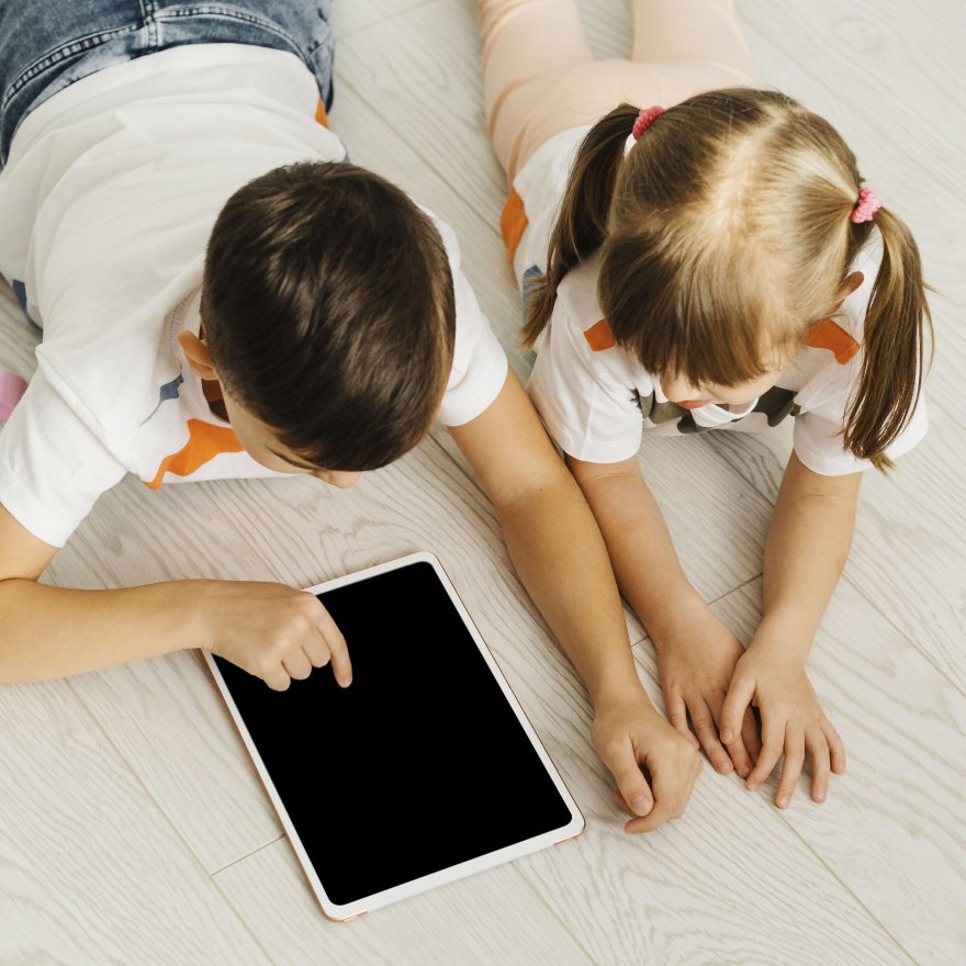 1737874436173siblings-using-digital-tablet-high-view.jpg